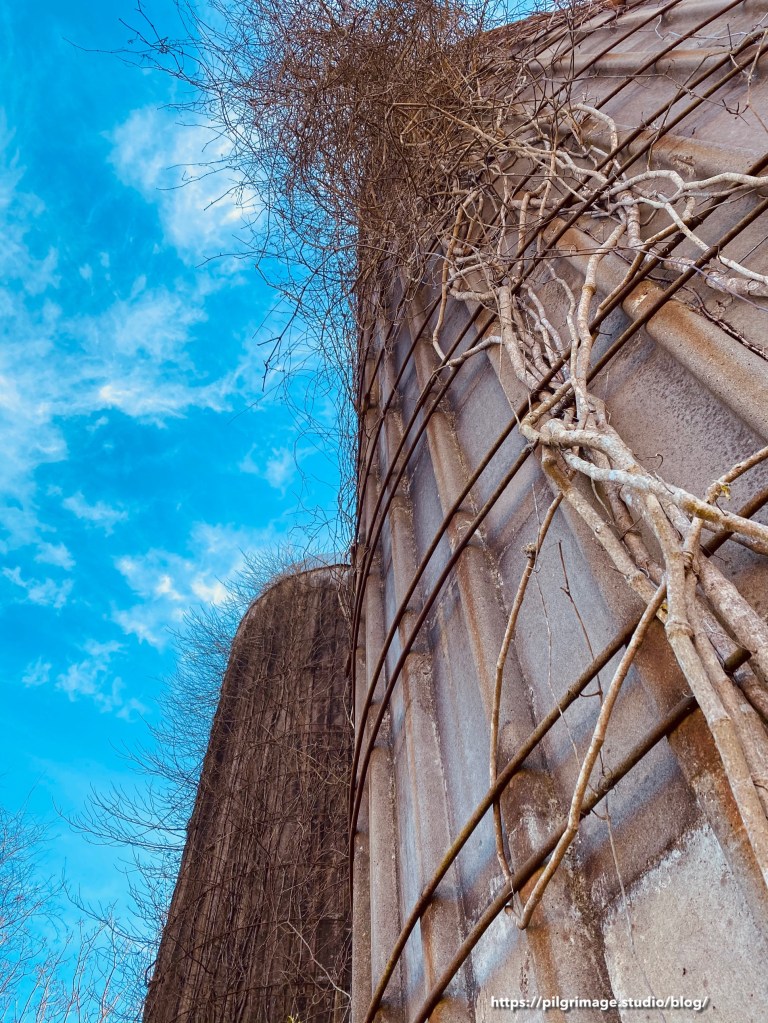 Bright blue sky above old silos 